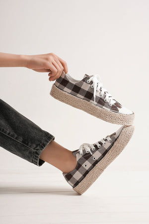 A stylish person showcasing ASH-08 Plaid Espadrille Sneakers by Beast Fashion, featuring a trendy plaid design and an espadrille-style jute-wrapped sole. Perfect for summer vacation, these new shoes combine comfort and style, ideal for casual outings and warm weather. Great addition for your sneaker collection.