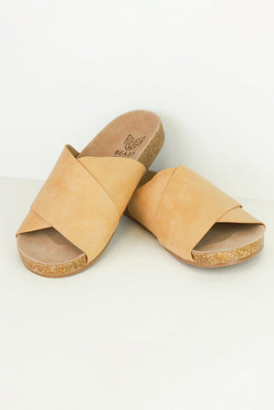 AVIANA-07 Cross-Strap Slide Sandals by Beast Fashion, featuring a stylish wide cross-strap design, perfect for summer vacations. These flat sandals are comfortable with a cork footbed, ideal for casual outings and available in multiple colors. Hot sale shoes for all-day wear.