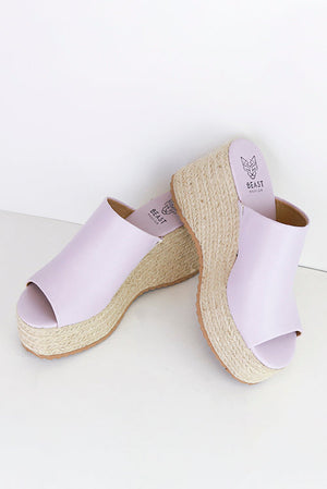 Lovely STACEY-01 espadrille platform mules by Beast Fashion featuring a lilac faux leather upper and jute-wrapped sole. Perfect for summer vacations, these stylish sandals add charm to any outfit.