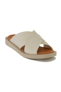 Side view of VICENTE-09 Crisscross Flat Sandals by Beast Fashion in beige. The fashionable slide sandals are perfect for summer outings, featuring a comfortable footbed and a chic crisscross design.