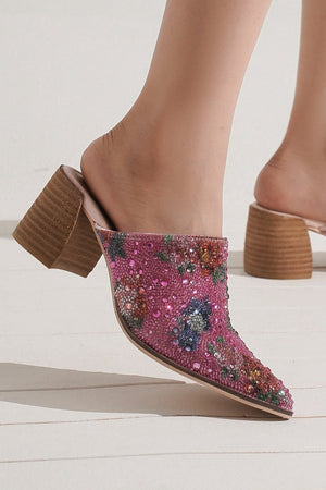Stylish pink embellished mule heels from Beast Fashion, featuring floral rhinestone details, perfect for special occasions. Ideal for those looking to add a chic touch to their outfit. Heeled Mules, Mules, New Shoes, Rhinestone, Rhinestone Detail.