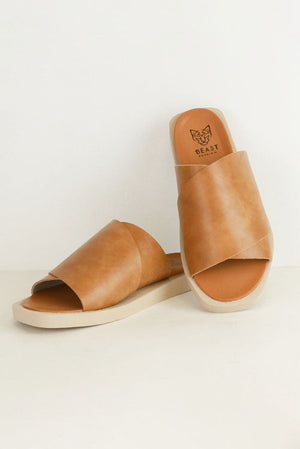 VICENTE-01 Crisscross Slip-On Sandals by Beast Fashion in camel color, featuring a stylish crisscross strap design, perfect for summer vacations. These flat sandals offer ultimate comfort with a cushioned footbed, making them a go-to choice for casual outings.